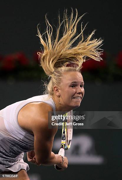 Caroline Wozniacki of Denmark hits a serve to Agnieszka Radwanska of Poland during the BNP Paribas Open at the Indian Wells Tennis Garden on March...