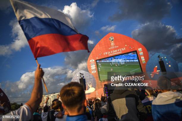 Russian fans cheer their team during the Russia 2018 World Cup Group A football match between Russia and Egypt, at the Fan Zone in Kaliningrad on...