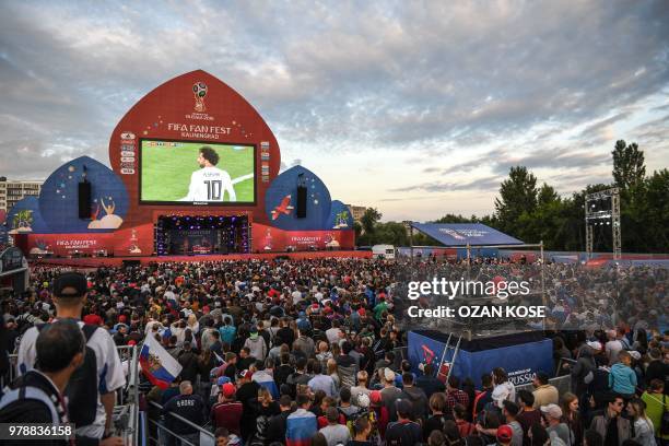 Russian fans cheer their team during the Russia 2018 World Cup Group A football match between Russia and Egypt, at the Fan Zone in Kaliningrad on...