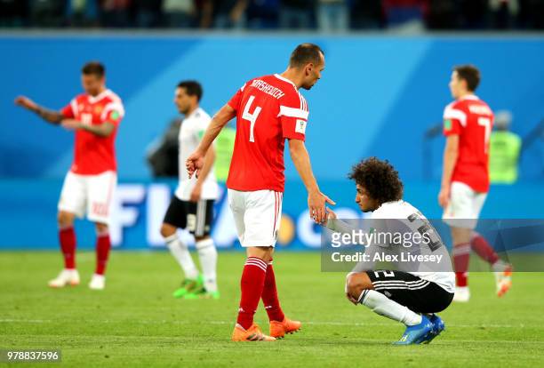 Amr Warda oh Egypt is consoled by Sergey Ignashevich of Russia during the 2018 FIFA World Cup Russia group A match between Russia and Egypt at Saint...