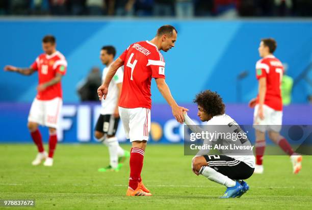 Amr Warda oh Egypt is consoled by Sergey Ignashevich of Russia during the 2018 FIFA World Cup Russia group A match between Russia and Egypt at Saint...