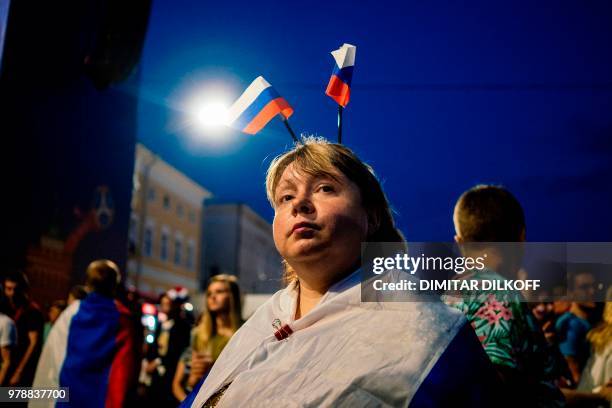 Russian fan watches her team during the Russia 2018 World Cup Group A football match between Russia and Egypt, at the Fan Zone in Nizhny Novgorod on...