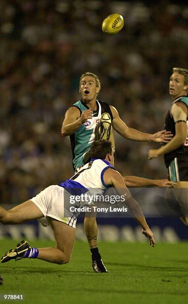 Jarrad Schofield for Port Adelaide kicks past Clayton Lasscock for the Kangaroos in the Ansett Cup semi-final match between Port Power and the North...