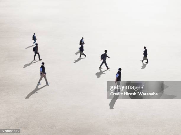 men walking in the square - moving past ストックフォトと画像