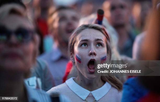 Russian fan reacts as she watches a screening of the Russia 2018 World Cup Group A football match between Russia and Egypt, at the Fan Zone in Nizhny...