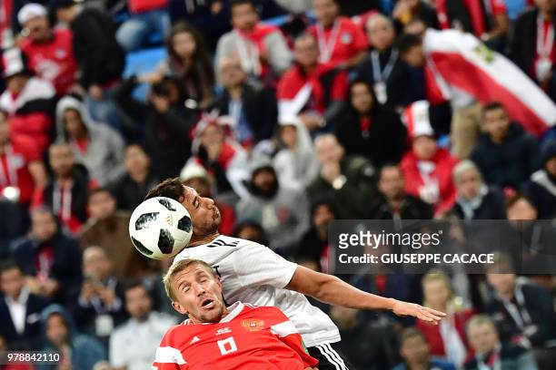 Russia's midfielder Yuri Gazinskiy vies with Egypt's forward Mahmoud 'Trezeguet' Hassan during the Russia 2018 World Cup Group A football match...