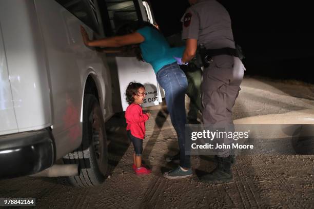 Two-year-old Honduran asylum seeker cries as her mother is searched and detained near the U.S.-Mexico border on June 12, 2018 in McAllen, Texas. The...