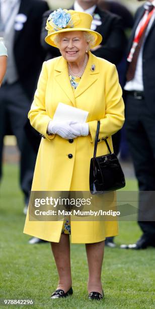 Queen Elizabeth II watches her horse 'Fabricate' run in the Wolferton Stakes on day 1 of Royal Ascot at Ascot Racecourse on June 19, 2018 in Ascot,...