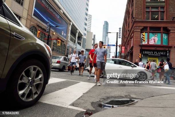 Pedestrian cross Shuter St. At Yonge St., June 18, 2018. Community Leaders Release #BuildTheVisionTO: Safe and active streets for all.