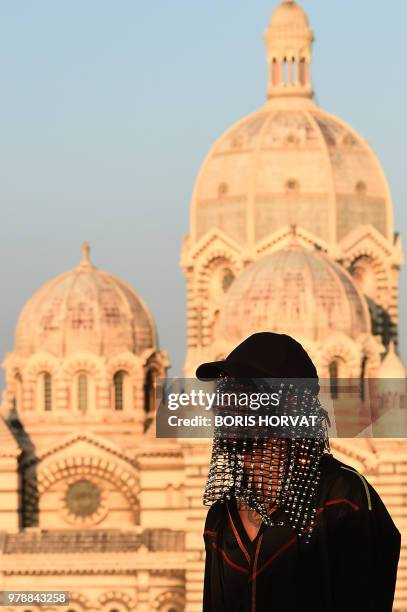 Model presents a creation for Koche fashion house during "Open My Med" fashion show on June 19, 2018 in Marseille. - In the background, the Cathedral...