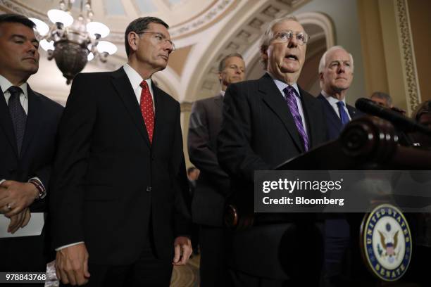 Senate Majority Leader Mitch McConnell, a Republican from Kentucky, right, speaks during a news conference following a Senate weekly luncheon meeting...