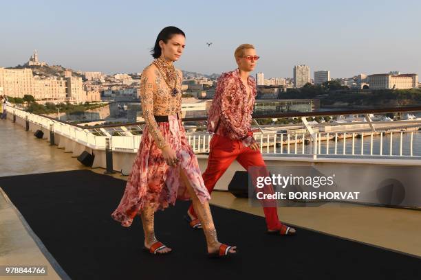 Models present creations for Koche fashion house during "Open My Med" fashion show on June 19, 2018 in Marseille.