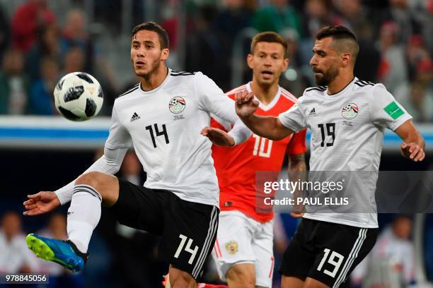 Egypt's midfielder Ramadan Sobhi and Egypt's midfielder Abdallah Said play during the Russia 2018 World Cup Group A football match between Russia and...