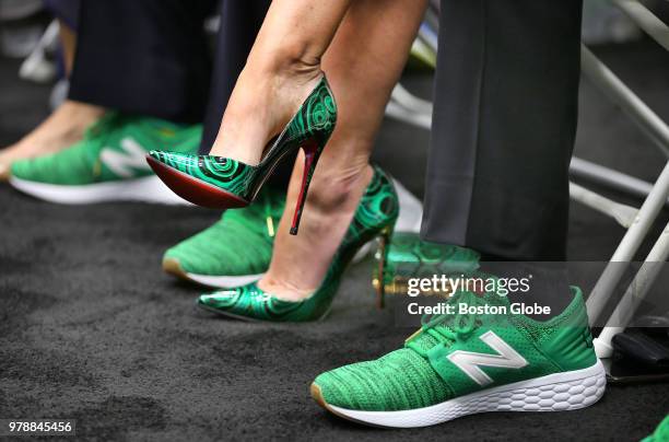 The high heels worn by Emilia Fazzalari, wife of Boston Celtics CEO Wyc Grousbeck, are pictured next to Grousbeck's green New Balance basketball...