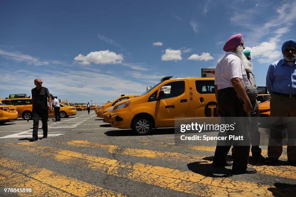 Taxi drivers gather at John F. Kennedy Airport while waiting their turn to pick up a passenger on June 19, 2018 in New York City. Following the...