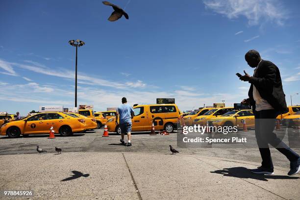 Taxi drivers gather at John F. Kennedy Airport while waiting their turn to pick up a passenger on June 19, 2018 in New York City. Following the...