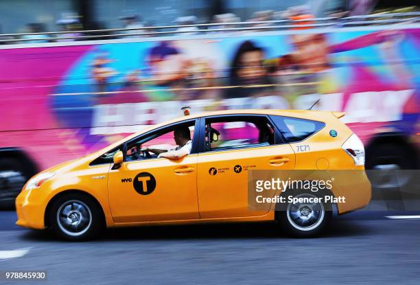 Taxi drives through the streets of New York on June 19, 2018 in New York City. Following the suicide death of the sixth New York City cab driver in...