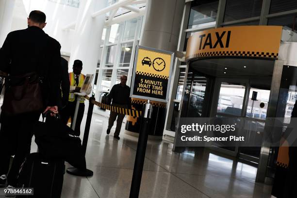 Man walks through an empty taxi line at John F. Kennedy Airport on June 19, 2018 in New York City. Following the suicide death of the sixth New York...