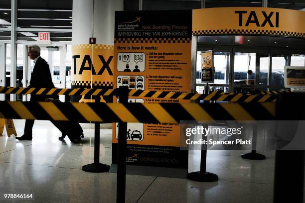 Man walks through an empty taxi line at John F. Kennedy Airport on June 19, 2018 in New York City. Following the suicide death of the sixth New York...