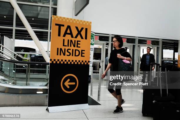 Sign advertises directions to a taxi stand at John F. Kennedy Airport on June 19, 2018 in New York City. Following the suicide death of the sixth New...