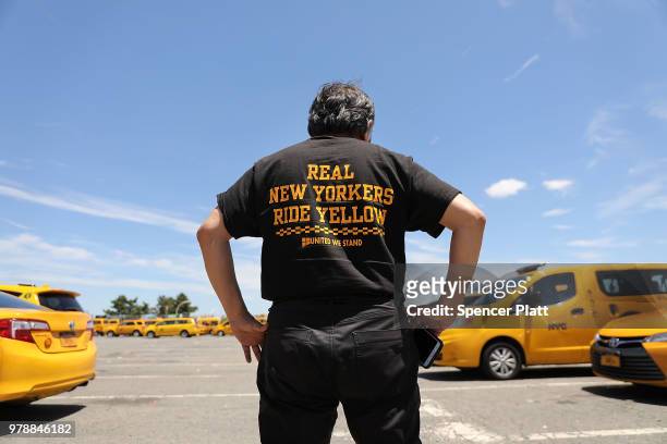 Taxi driver Nino Hervias waits in a taxi lot at John F. Kennedy Airport while waiting on June 19, 2018 in New York City. Following the suicide death...