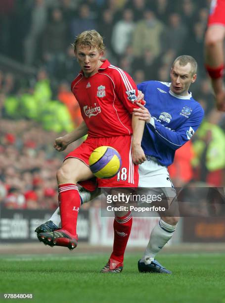 Dirk Kuyt of Liverpool and Tony Hibbert of Everton in action during the Barclays Premiership match between Liverpool and Everton at Anfield in...