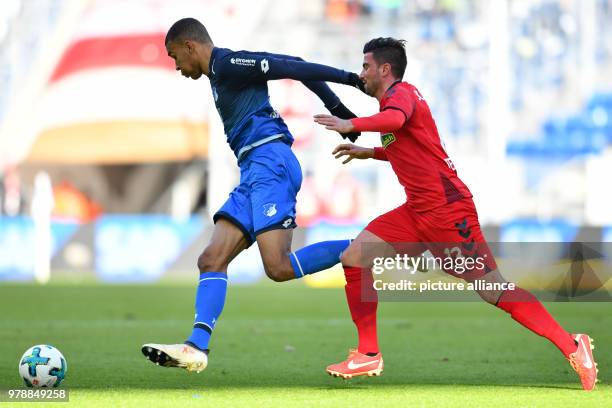 February 2018, Germany, Sinsheim: German Bundesliga match between 1899 Hoffenheim and SC Freiburg at the Rhein-Neckar-Arena. Hoffenheim's Kevin...