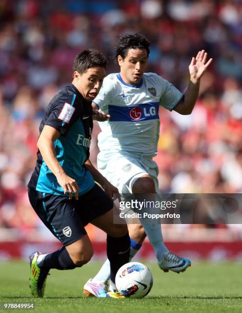 Samir Nasri of Arsenal and Leandro Somoza of Boca Juniors in action during the Emirates Cup match between Arsenal and Boca Juniors at the Emirates...