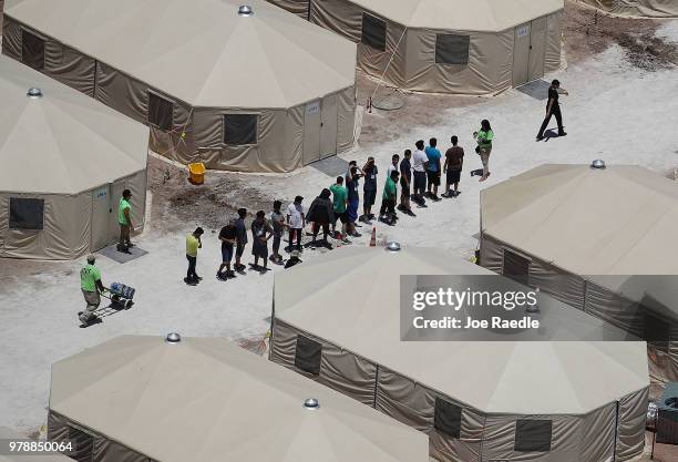 Children and workers are seen at a tent encampment recently built near the Tornillo Port of Entry on June 19, 2018 in Tornillo, Texas. The Trump...