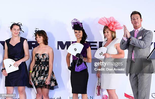 Richard Reid looks on as contestants participate in Fashions on the Field at Myer Ladies Day as part of the Golden Slipper Racing Carnival at...