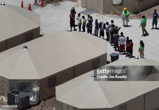 Children and workers are seen at a tent encampment recently built near the Tornillo Port of Entry on June 19, 2018 in Tornillo, Texas. The Trump...