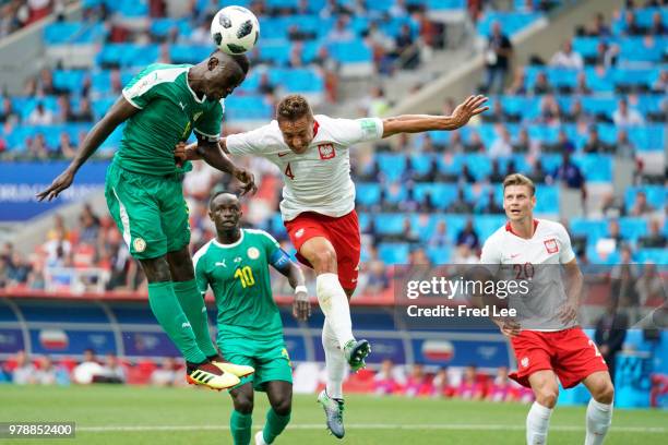 Mame Biram Diouf of Senegal vies with Thiago Rangel Cionek of Poland during the 2018 FIFA World Cup Russia group H match between Poland and Senegal...