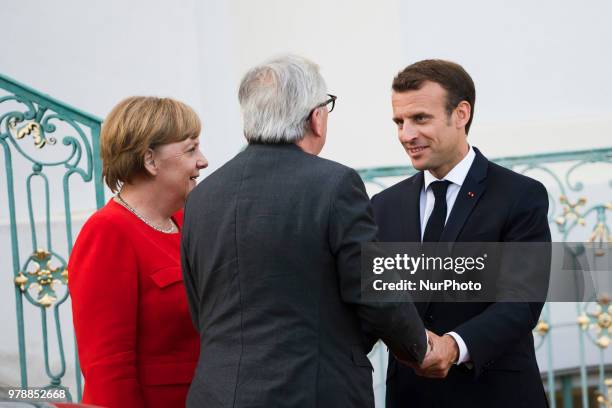 German Chancellor Angela Merkel and French President Emmanuel Macron greet President of the EU Commission Jean-Claude Juncker upon his arrival for a...