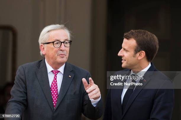 French President Emmanuel Macron and President of the EU Commission Jean-Claude Juncker chat before going to a meeting of the European Round Table of...