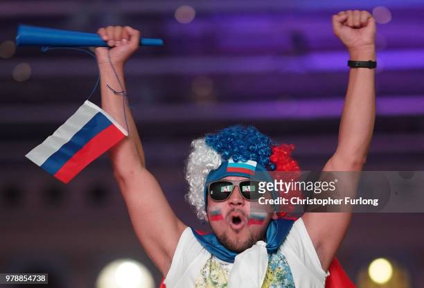 Russian football fans celebrate their national team's 3-1 win over Egypt as they watch a giant television near Red Square on June 19, 2018 in Moscow,...
