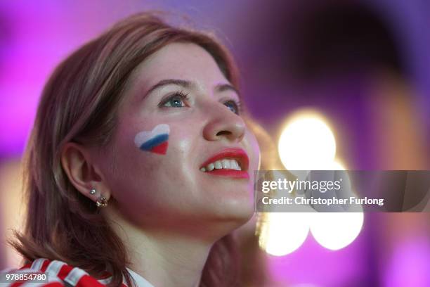 Russian football fans celebrate their national team's 3-1 win over Egypt as they watch a giant television near Red Square on June 19, 2018 in Moscow,...