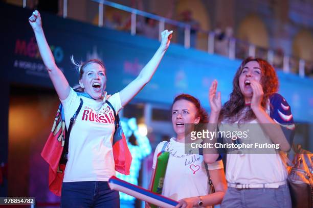Russian football fans celebrate their national team's 3-1 win over Egypt as they watch a giant television near Red Square on June 19, 2018 in Moscow,...
