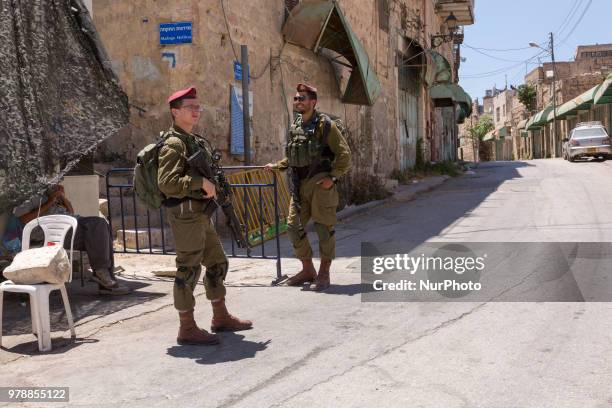 Soldiers on a check point between part of Hebron under Israels military control and Palestinian part of the city on June 14, 2018.