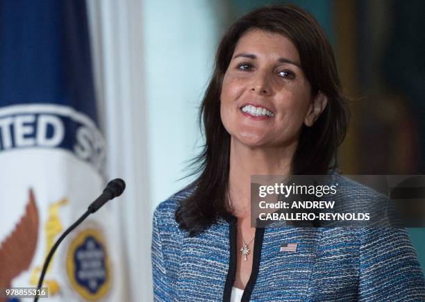 Ambassador to the United Nation Nikki Haley smiles at the US Department of State in Washington DC on June 19, 2018. - The United States announced...