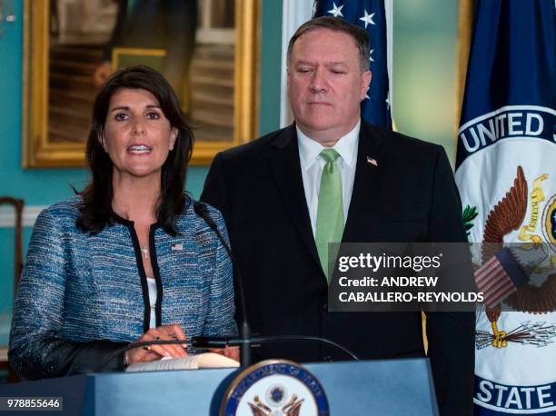 Secretary of State Mike Pompeo looks on as US Ambassador to the United Nation Nikki Haley speaks at the US Department of State in Washington DC on...