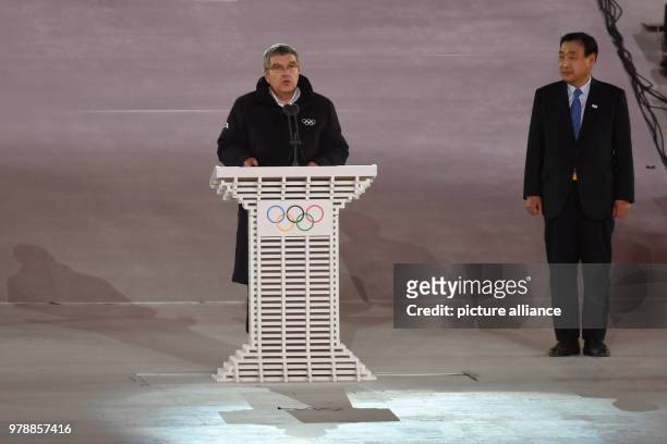 February 2018, South Korea, Pyeongchang: Olympics, Closing Ceremony, Olympic Stadium: German IOC president Thomas Bach holds a speech next to Hee...