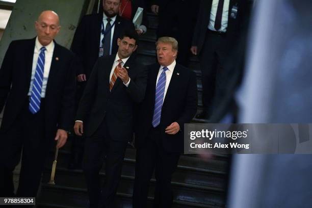 Accompanied by Speaker of the House Rep. Paul Ryan , U.S. President Donald Trump arrives at a meeting with House Republicans at the U.S. Capitol June...