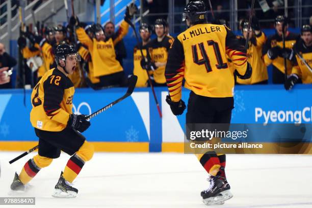 Germany's Dominik Kahun and teammate Jonas Muller celebrate their side's 2nd goal during the men's ice hockey gold medal match between Germany and...