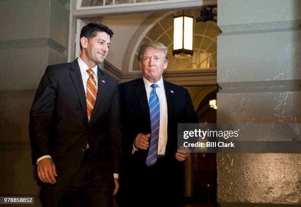 From left, Speaker of the House Paul Ryan, R-Wisc., escorts President Donald Trump to the House Republican caucus meeting in the basement go the...