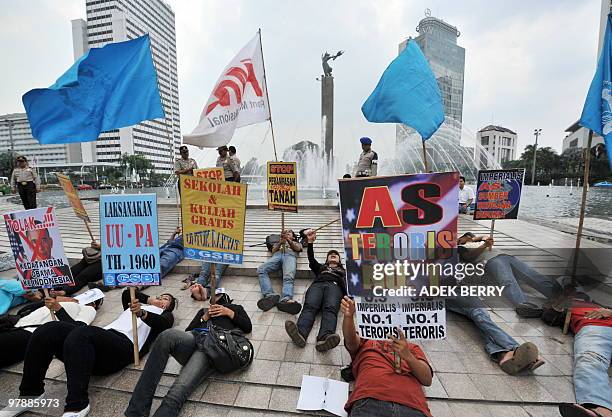 Indonesian labourers from 'Front Perjuangan Rakyat' protest against a potential visit by US President Barack Obama to Indonesia, in Jakarta on March...