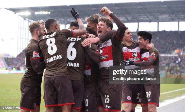 February 2018, Germany, Hamburg, Soccer, 2. Bundesliga, FC St.Pauli vs. Holstein Kiel, Millerntor Stadium: Hamburg's players cheer after the 3-2...