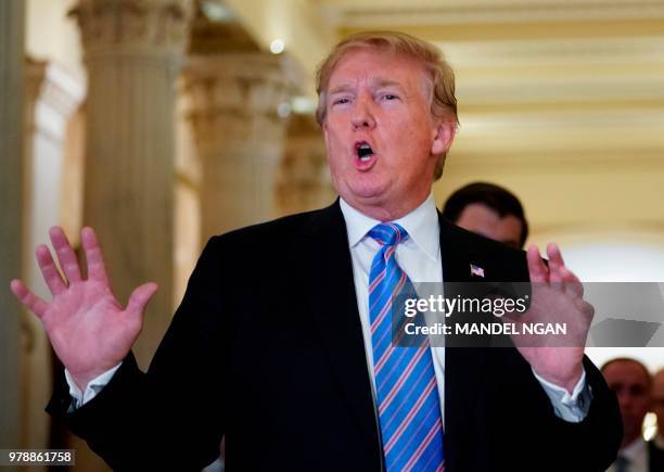 President Donald Trump speaks with the press after a meeting at the US Capitol with the House Republican Conference in Washington, DC on June 19,...