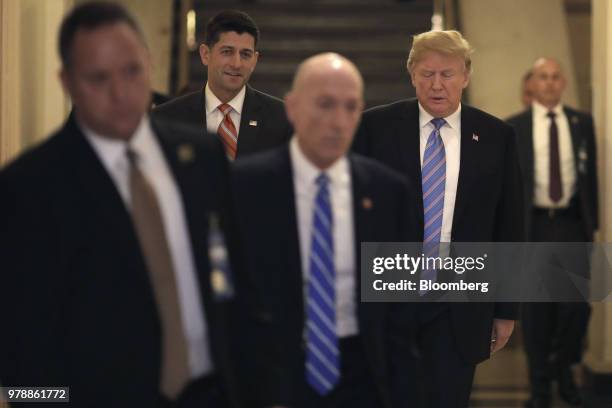 President Donald Trump, rear right, and U.S. House Speaker Paul Ryan, a Republican from Wisconsin, rear left, walk to a House Republican conference...