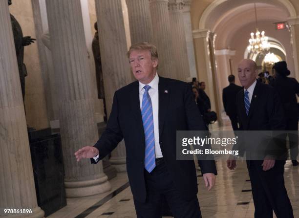 President Donald Trump speaks to members of the media while walking to a House Republican conference meeting on immigration legislation at the U.S....