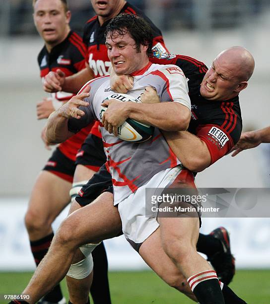 Cobus Grobbelaar of the Lions is tackled by Owen Franks of the Crusaders during the round six Super 14 match between the Crusaders and the Lions at...